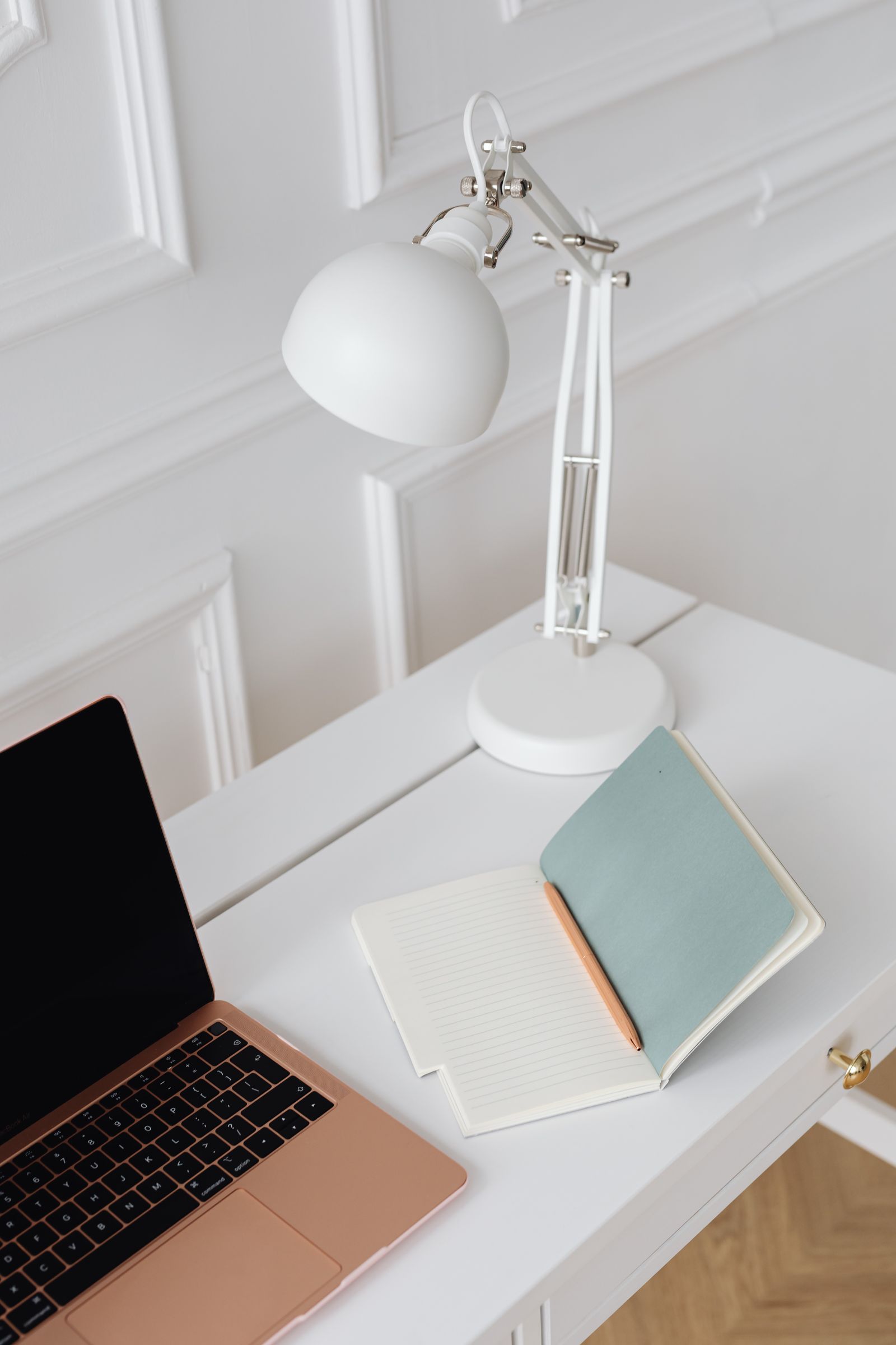 A laptop and notebook set up on a desk for focused learning